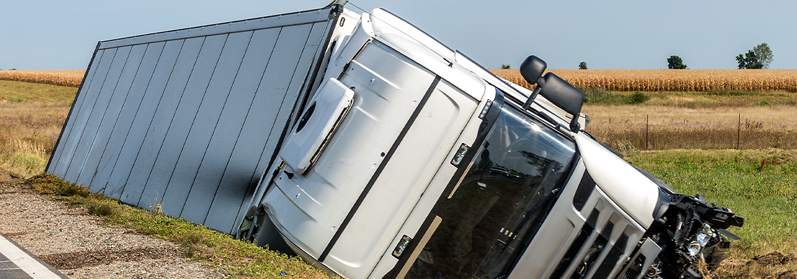 The truck lies in a side ditch after the road accident