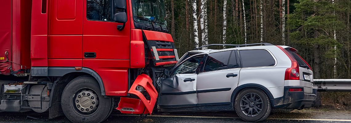 Truck collision with car in road