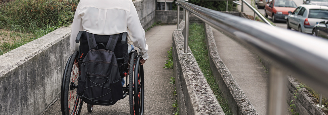 Person with physical disability moving in a manual wheelchair