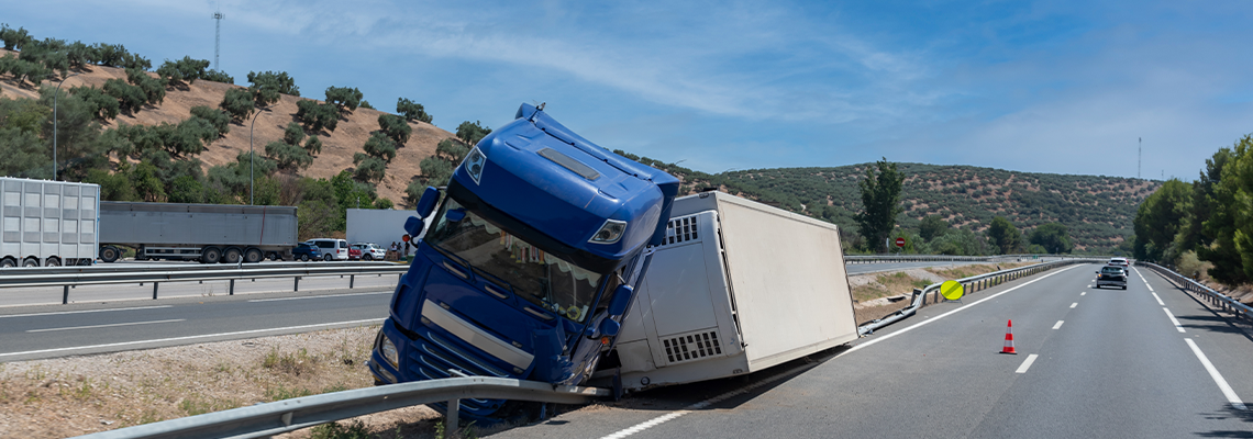 Truck with an accident refrigerated semi-trailer, overturned by the exit of the highway