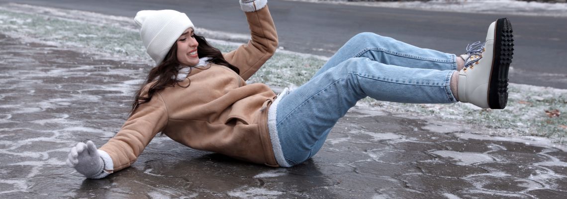 Women slips and fall on icy sidewalk