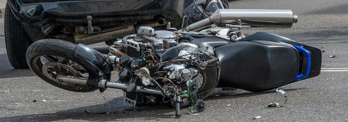 Damaged motorcycle on road after accident