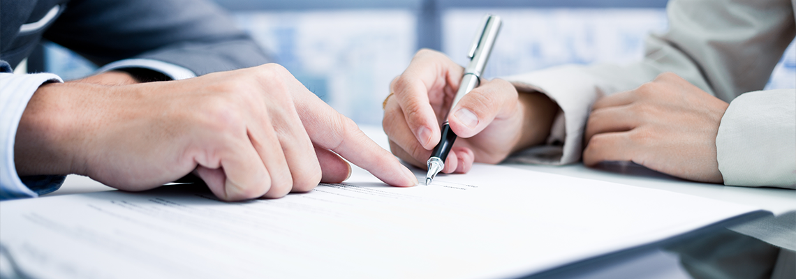 Female hand signing Petition with pen