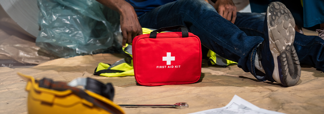 Emergency staff in safety suit use first aid kit to help a man
