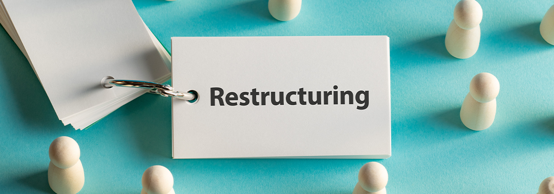 There is word card with the word Restructuring