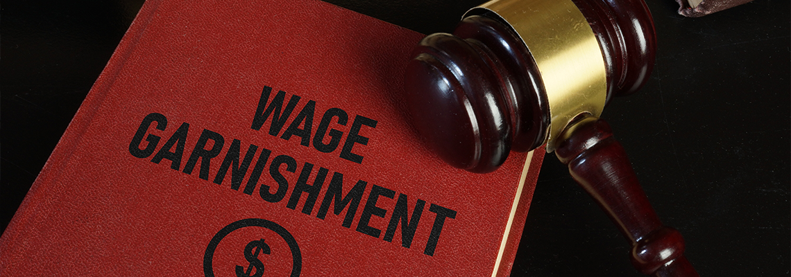 Wage garnishment is shown using the text with gavel on table