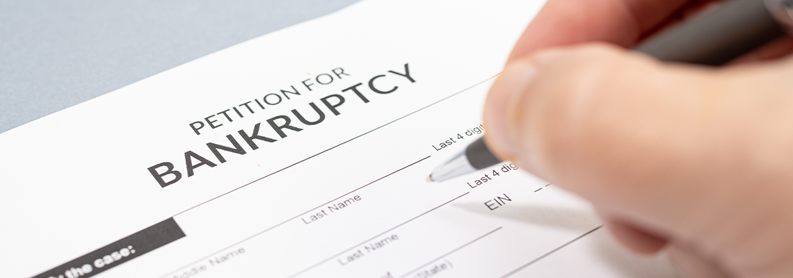 Hand filling a Bankruptcy form