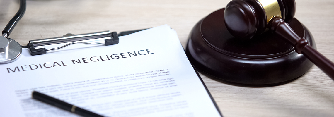 Medical negligence and stethoscope on table, gavel