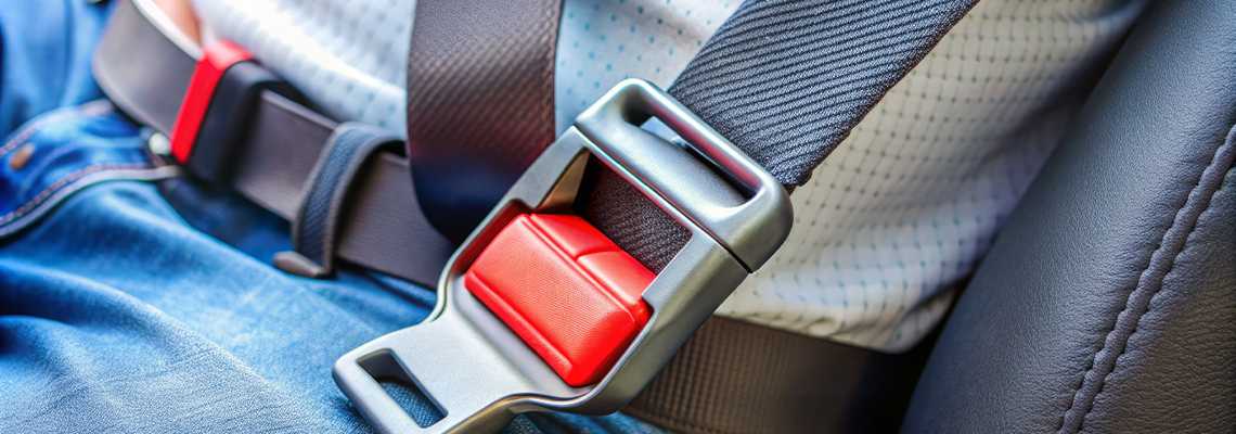 A close-up of a safety belt being securely fastened into a buckle
