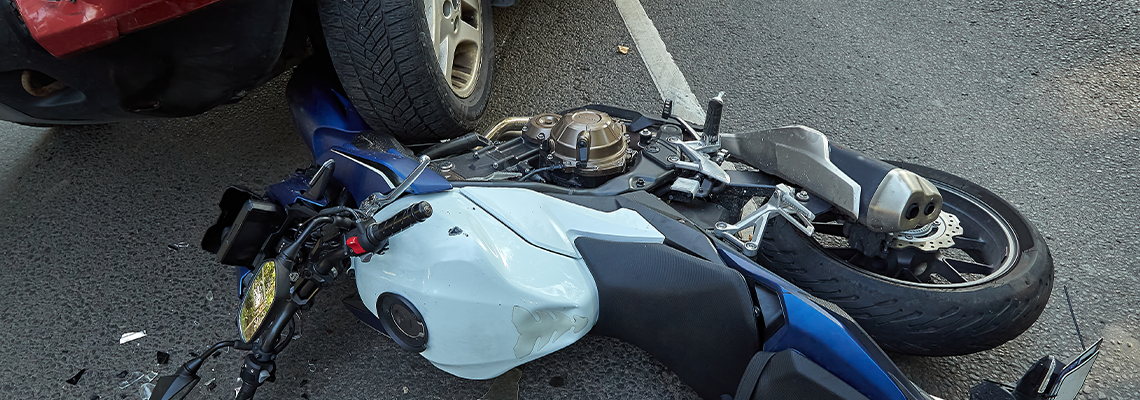 Damaged motobike and a car in a accident