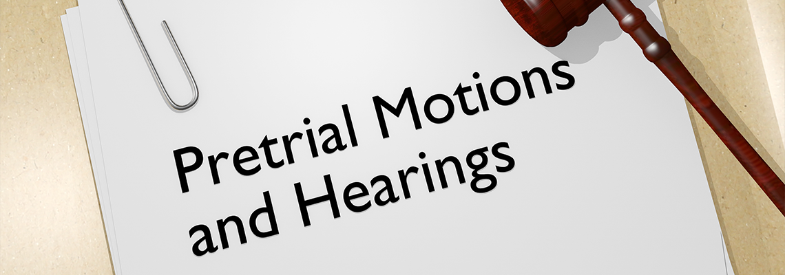 Pretrial Motions and Hearings written on a Paper and Gavel