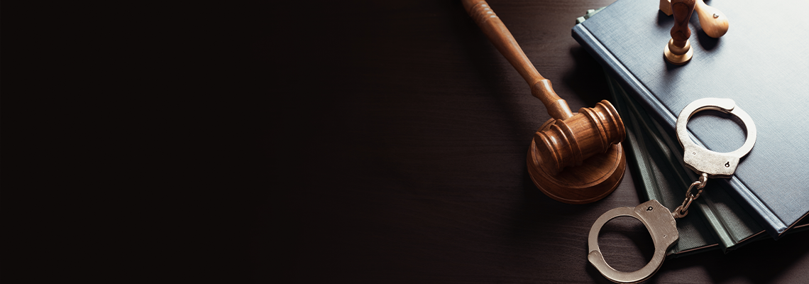 Crime and violence concept with handcuffs and gavel on table