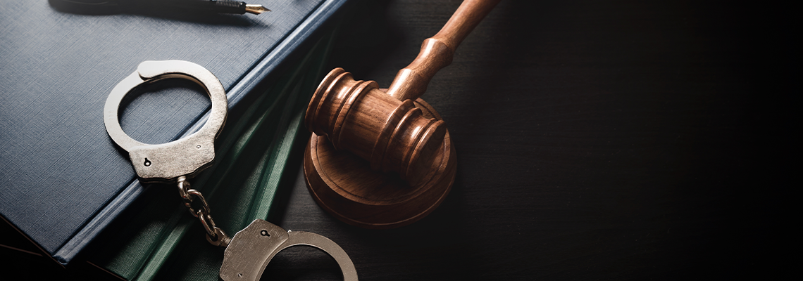 Handcuffs and wooden gavel