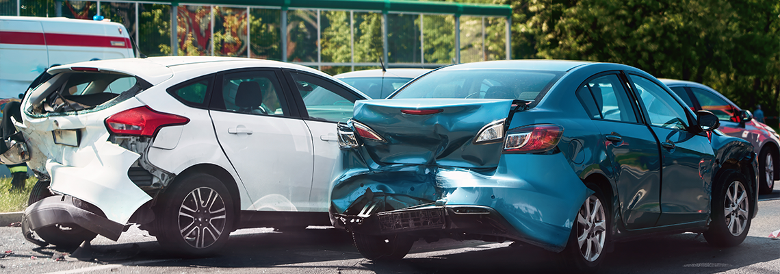 Traffic collision scene with damaged cars