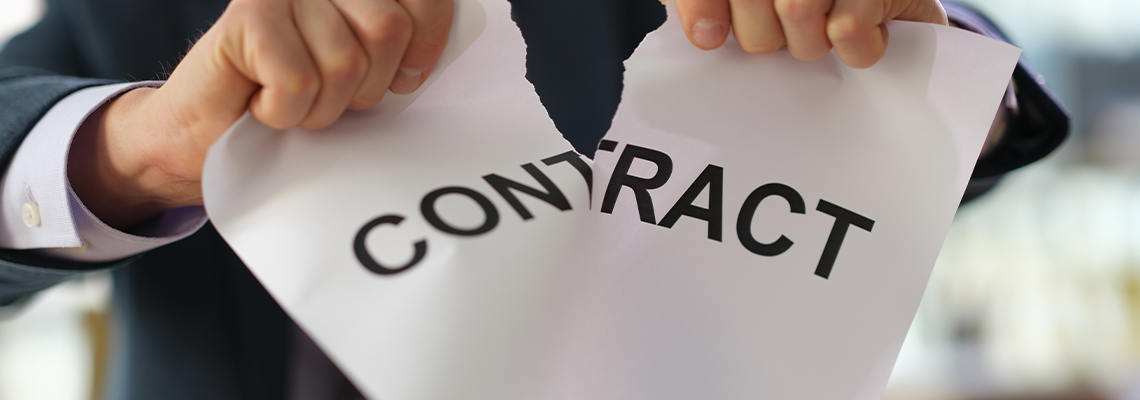 Businessman in suit tearing paper document contract at work in office