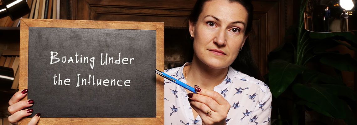 Women holding chalkboard that reads Boating under the influence