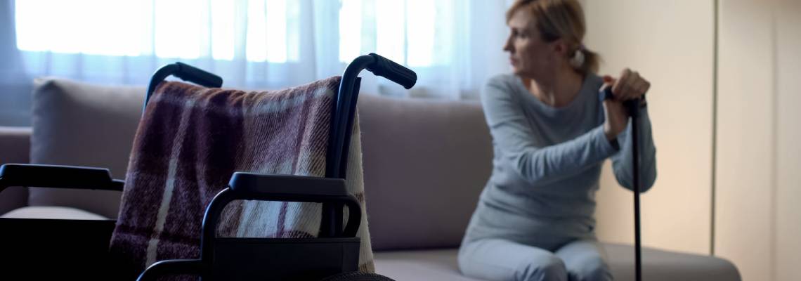 Women besides wheelchair in home