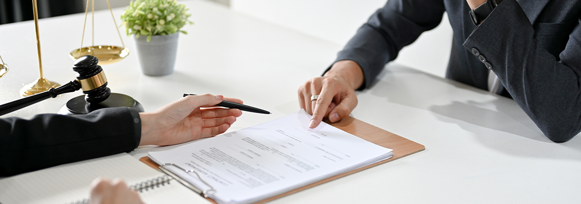 A professional male lawyer has a meeting with a client to provide counseling