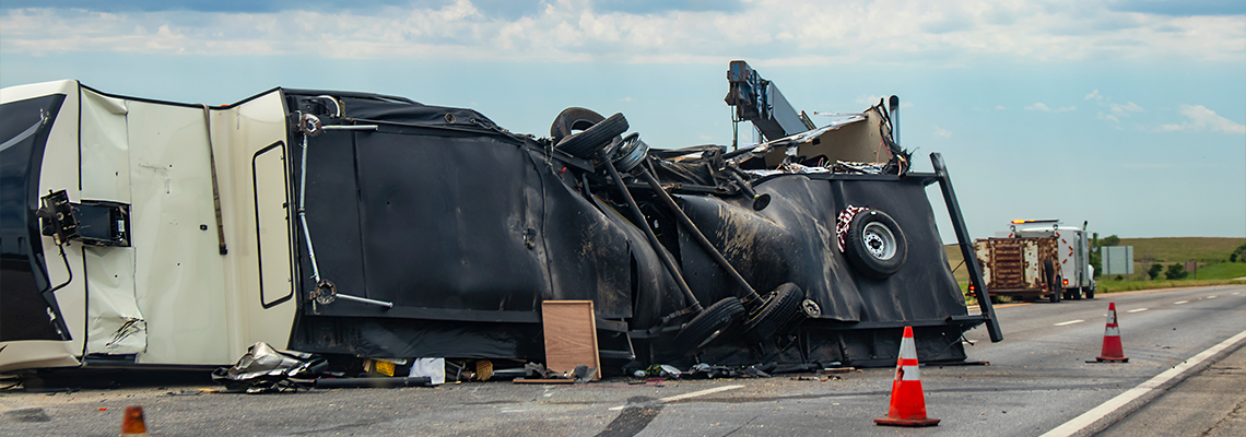 Fifth wheel Recreational Vehicle overturned on a highway with the underside torn up