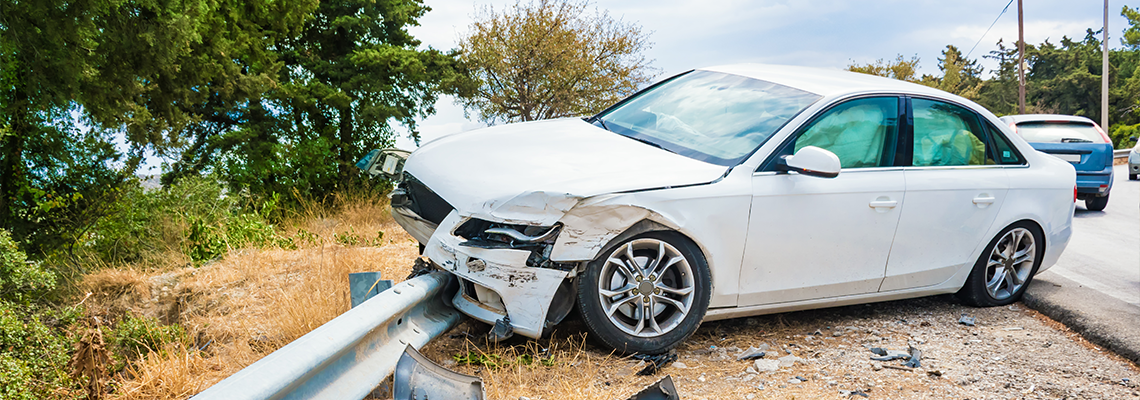 Crashed car with deflated airbags after accident finished on road crashed barrier