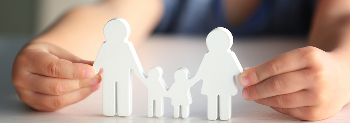 Child holding figure in shape of happy family