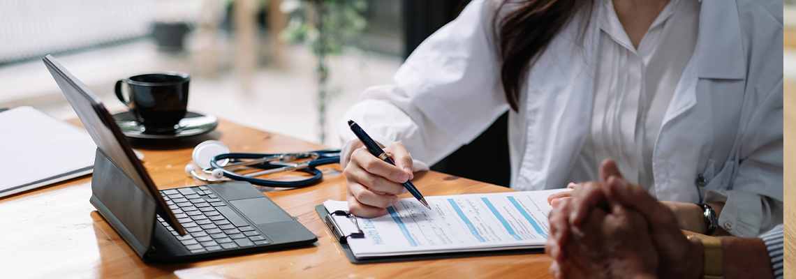 Female health insurance broker presenting his insurance benefits to businessman fill