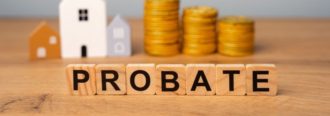 Probate word on wooden cubes with house models and stack of coins