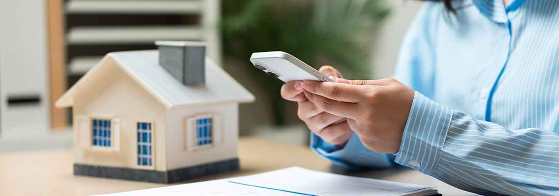 Home insurance and property management concept with smartphone technology