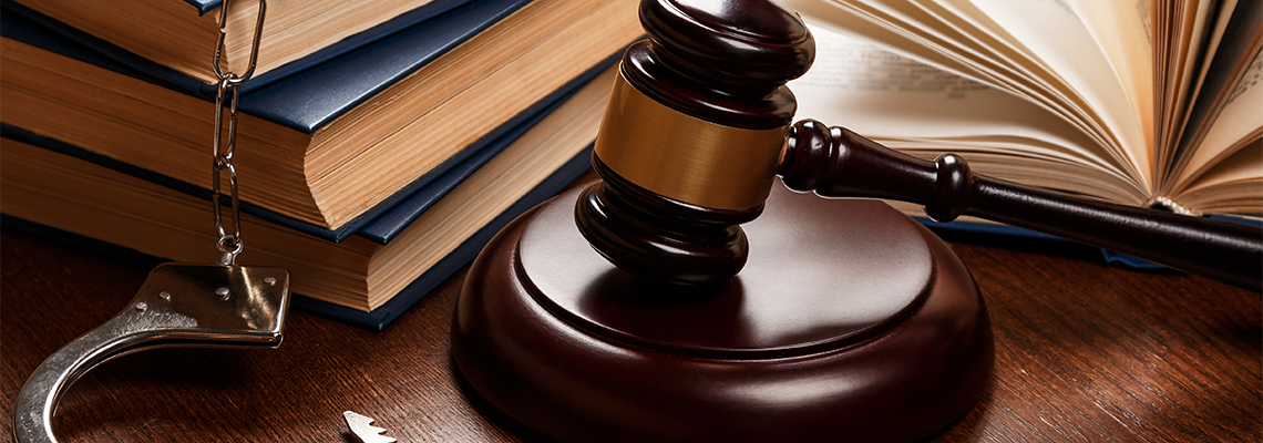Gavel, books and handcuffs