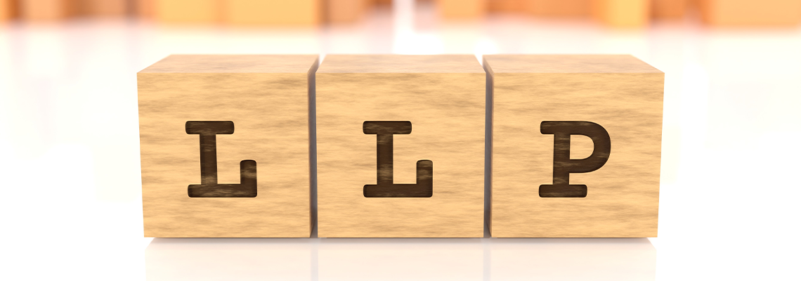 Word with the text LLP engraved on wooden cubes reflected on the beautiful surface