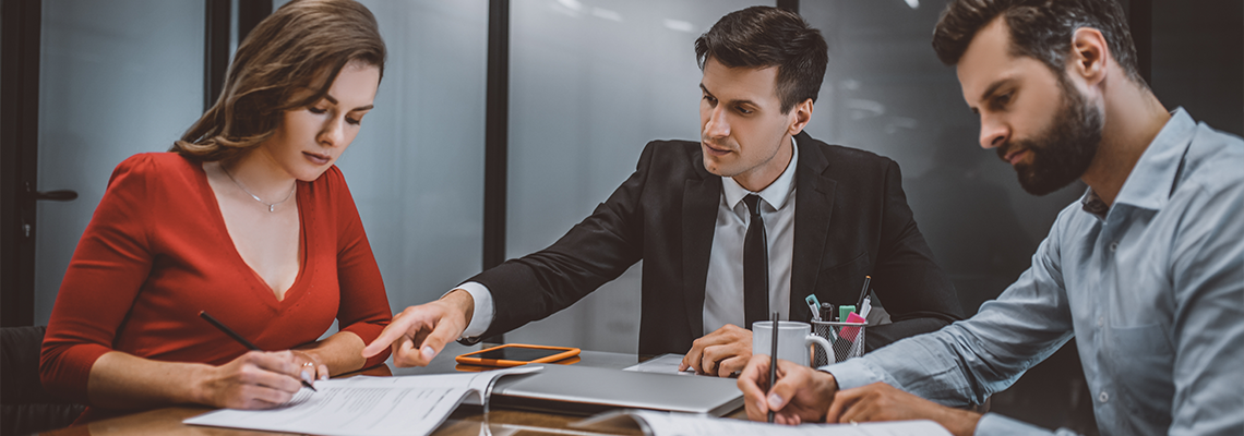 Professional lawyer consulting spouses about legal documents