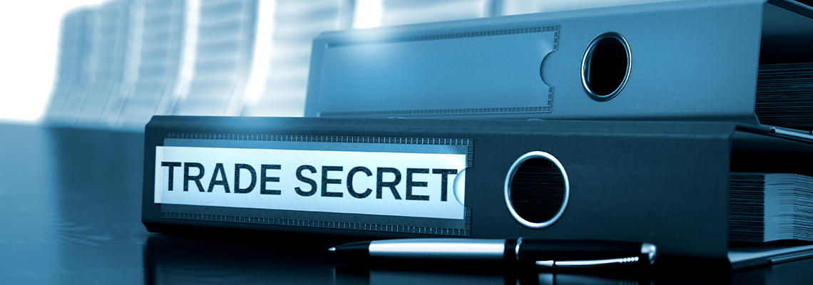 Folder with Inscription Trade Secret on Wooden Desktop