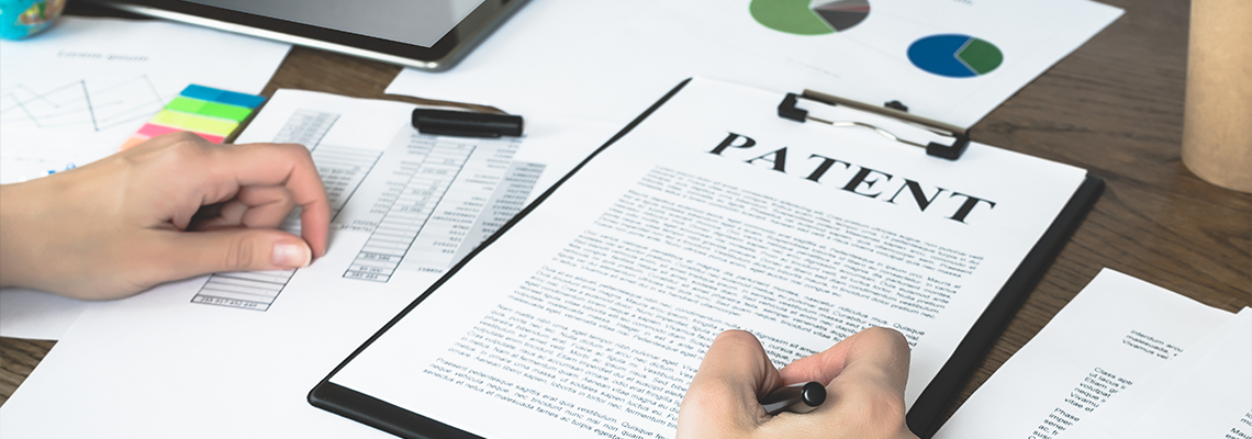 Business woman signs a patent. Intellectual property protection concept