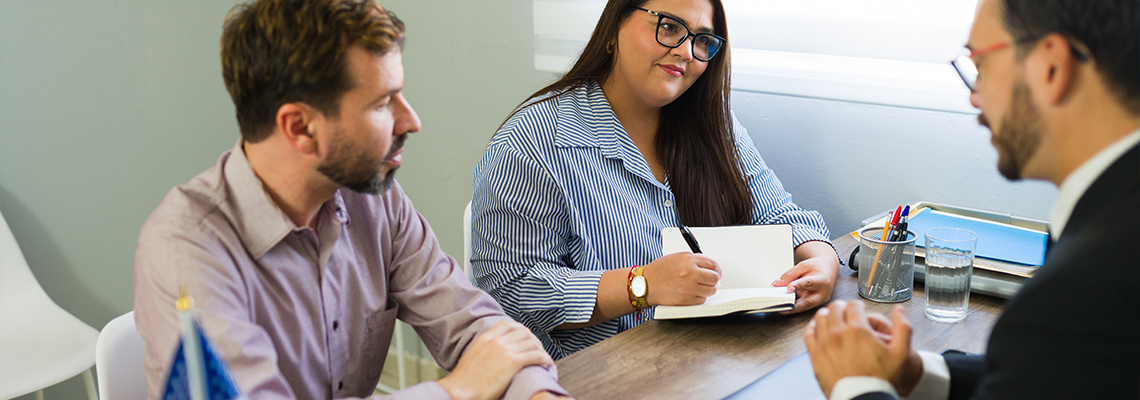 Latin couple meeting immigration lawyer for legal advice