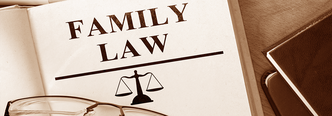Book with words family law and glasses.