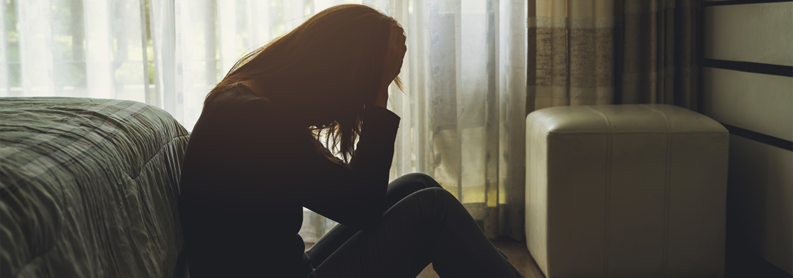 Lonely Woman Feeling Depressed and Stressed Sitting Head in Hands