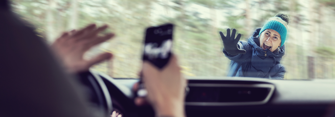 Pedestrian accident - man using a phone while driving a car