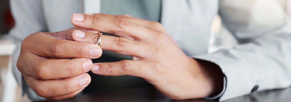 Women removing weeding ring from hand