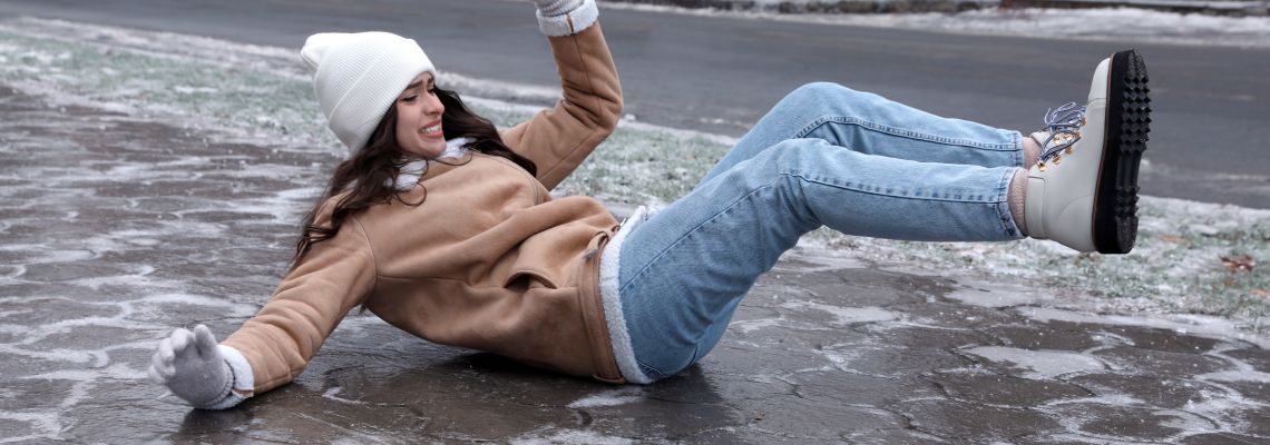 Women slips and falls on icy pavement