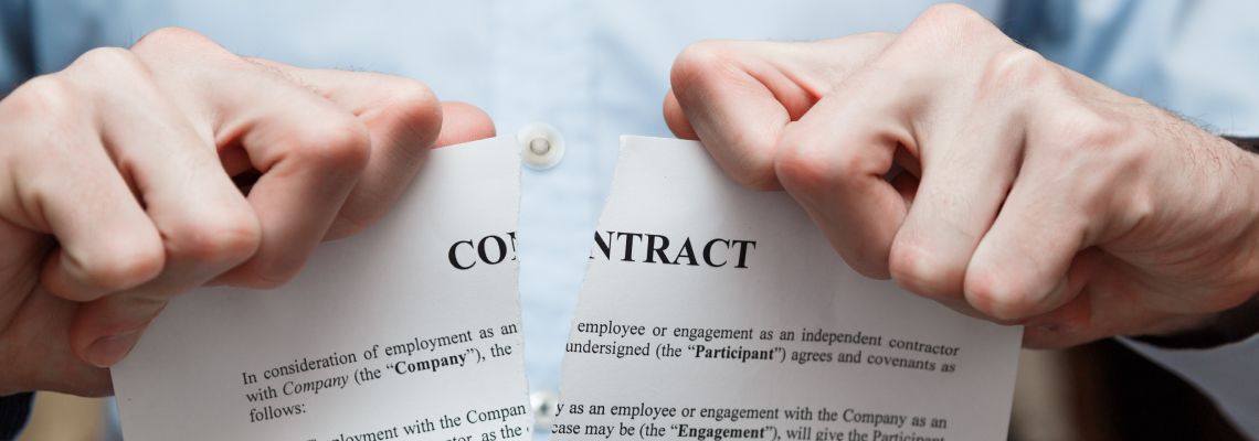 Businessman tearing contract paper