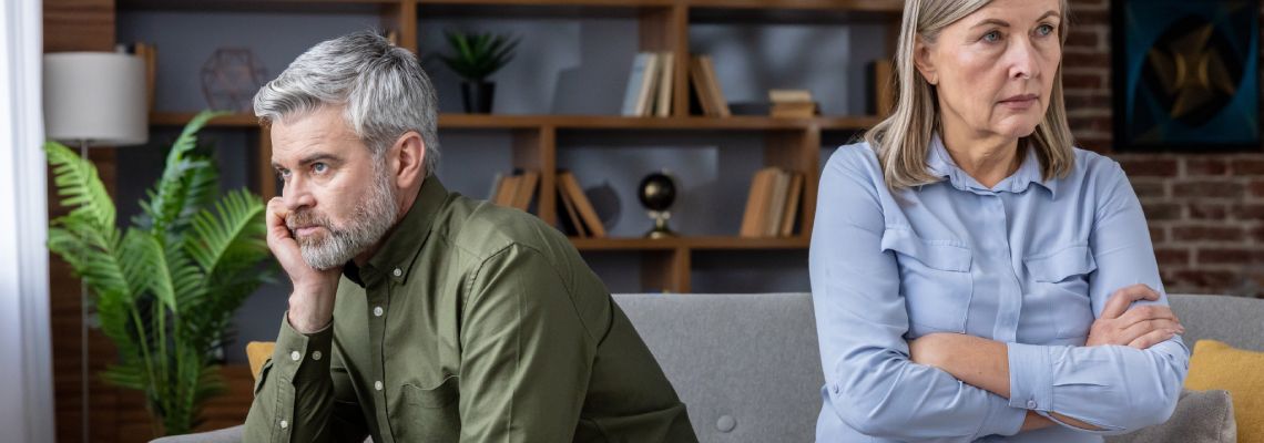 Dissatisfied senior man and woman sitting apart