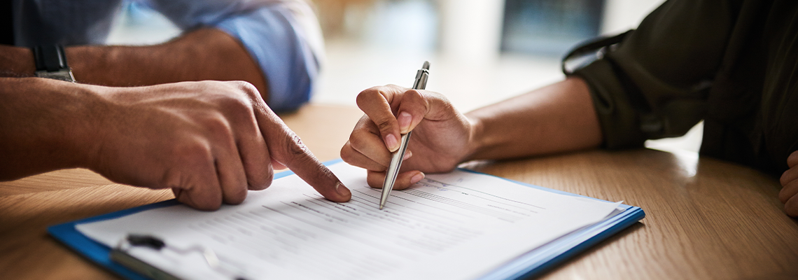 Lawyer signing a will contract agreement with client