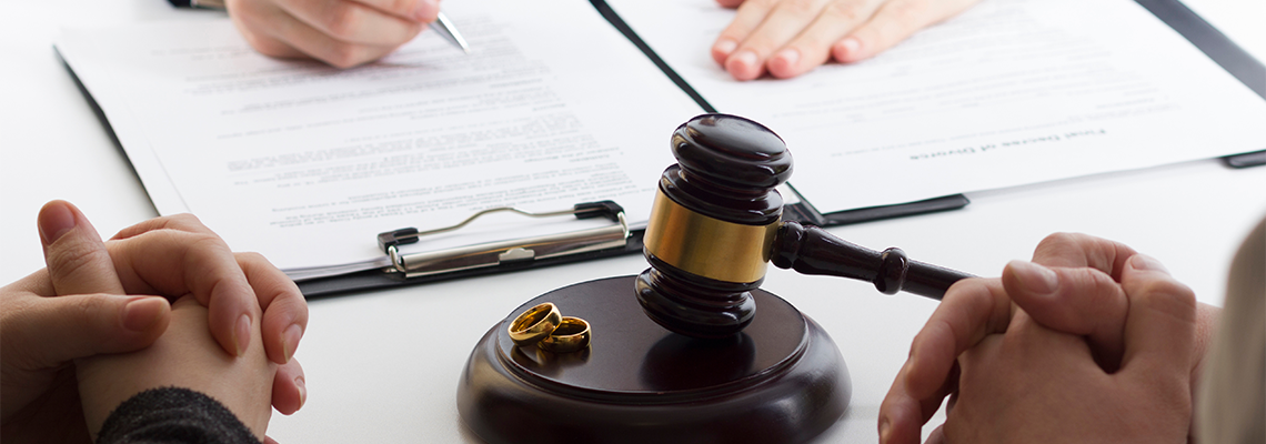 Hands of wife, husband signing decree of divorce, dissolution, canceling marriage