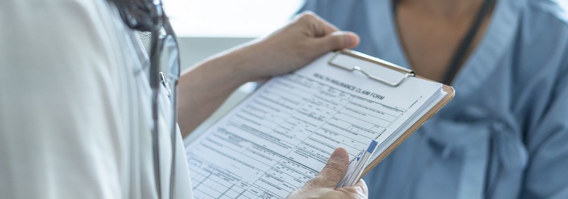 Patient with doctor holding personal injury form