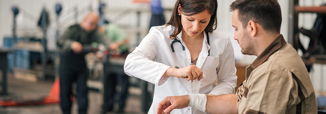 Beautiful female doctor examining factory worker.