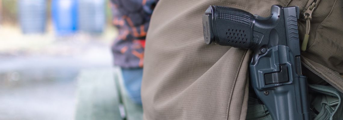 Gun inside holster carried by a man