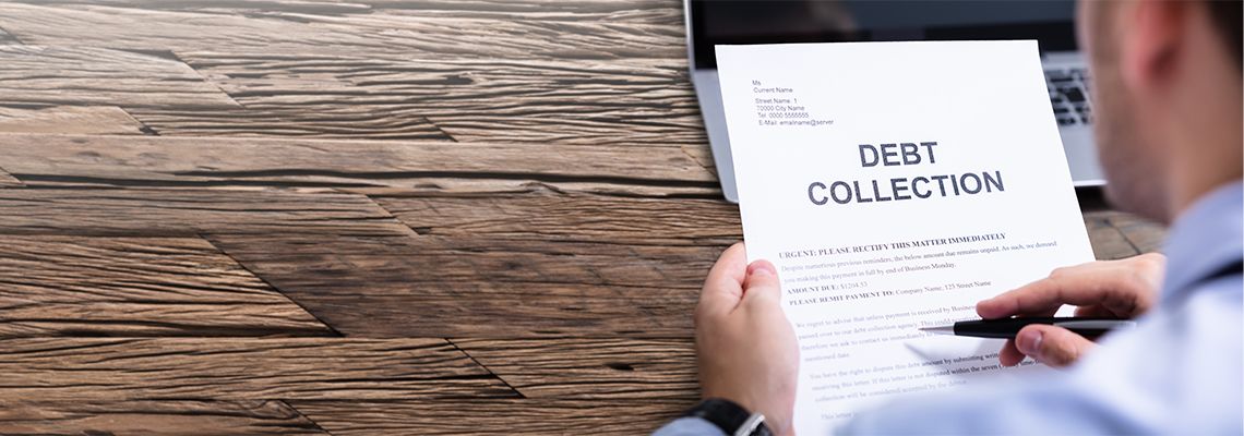 Man Reading Debt Collection Letter