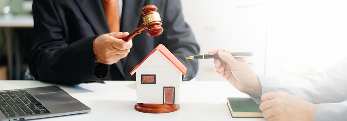 Lawyer handling house foreclosure law with gavel and home model