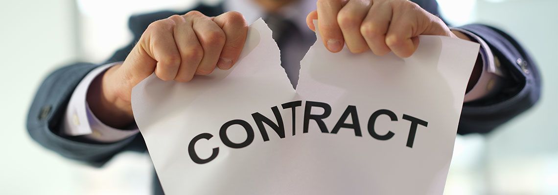 Businessman tearing contract paper