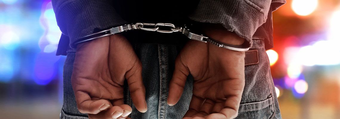 Handcuffed hands of man behind his back